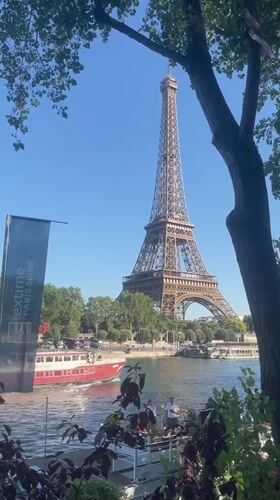 Seine river traffic and a riverside memorial near the Eiffel Tower