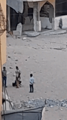 Children play in Khan Yunis streets surrounded by war damage