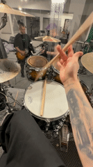 Drummer prepares to play kit in Шемякино, Russia