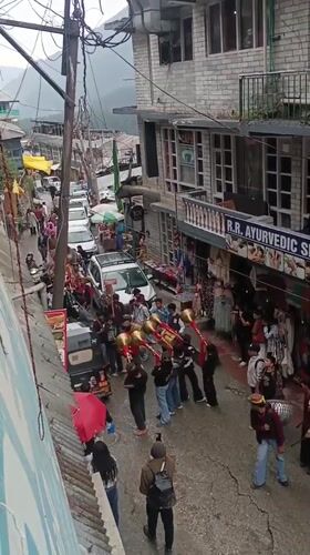 Rainy festival day captured in Vashisht mountain village