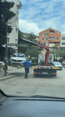 Tow truck removes silver Fiat from Budva street