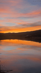 Evening fishing scene captured during colorful sunset in Bulgarian countryside