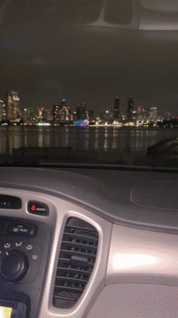 Nighttime skyline view captured from parked car in Coronado