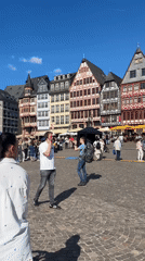 Frankfurt public square bustling with street performers and outdoor displays