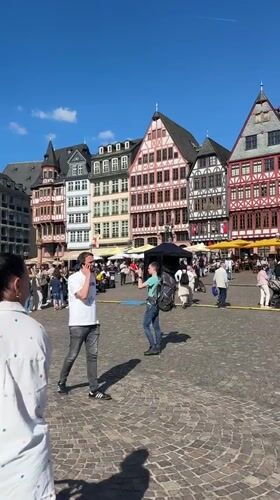 Frankfurt public square bustling with street performers and outdoor displays