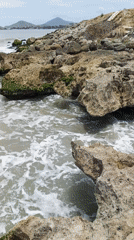 Visitor documents Juan Griego coastline during afternoon exploration