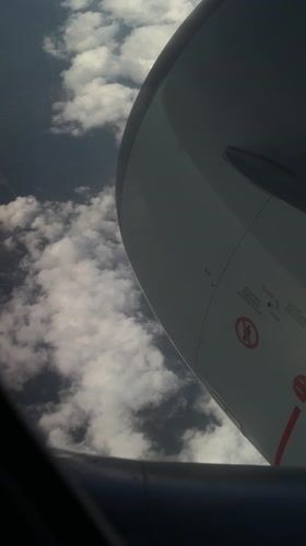 Passengers document aerial wing views during evening flight over Lamont