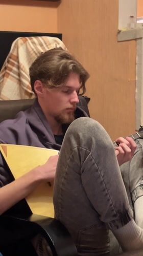 Young man plays balalaika during gaming session in Rostov