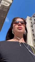 Woman in sunglasses walks through central London