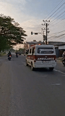 Ambulance with flashing lights observed in Lhokseumawe at dusk