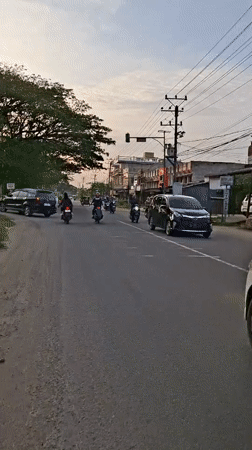 Ambulance with flashing lights observed in Lhokseumawe at dusk