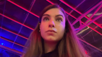 Woman photographed in colorfully lit geometric space in Đà Nẵng