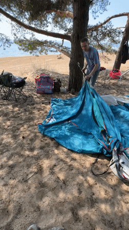 Camper sets up tent in Russian pine forest