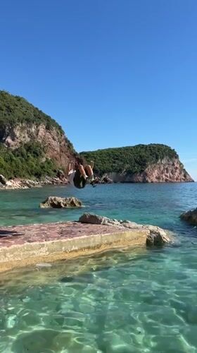 Tourists enjoy clifftop recreation at Montenegro's Sveti Stefan resort