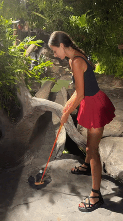 Woman plays mini-golf at themed course in Karon, Thailand