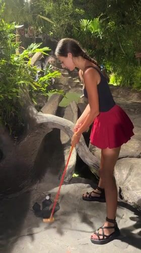 Woman plays mini-golf at themed course in Karon, Thailand