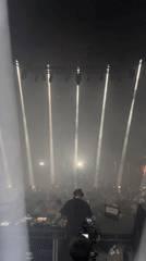 DJ performs for London crowd under spotlights