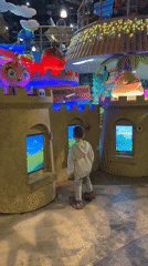 Mother, child enjoy indoor playground with interactive screens in Petersburg