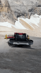 Snow groomers parked on an alpine slope near the Austrian-German border