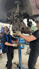 Mechanics install transmission at Blagoveshchensk auto repair shop