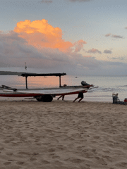 Tourist captures sunset moments with locals at Kuta Beach