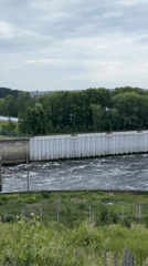 Tourist visits Chaikovsky hydroelectric dam, documents scenic river views