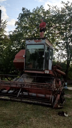 Old combine harvester gets a once-over in a Ukrainian field