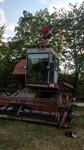 Old combine harvester gets a once-over in a Ukrainian field