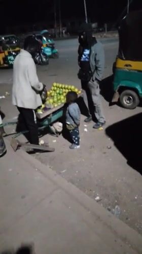 Night market activity in Bukuru, Nigeria — vendors, keke napeps, street food