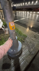 Abandoned shopping cart blocks wet Saint Petersburg crosswalk overnight