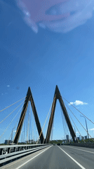 Vehicle crosses modern bridge in sunny Kazan morning