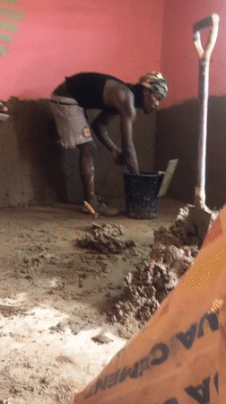 Workers renovate pink-walled room at New Stadium, Nigeria