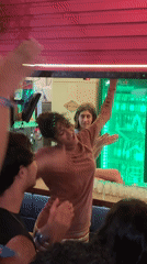 Lively celebration captured at São Paulo bar during evening hours