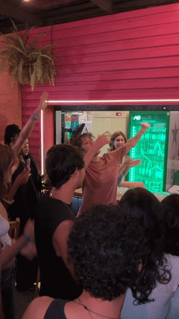 Lively celebration captured at São Paulo bar during evening hours