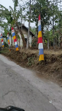 Roadside life in Sumedang: banners, cleanup, and green surroundings