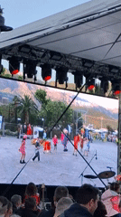 Outdoor stage performance recorded from audience perspective