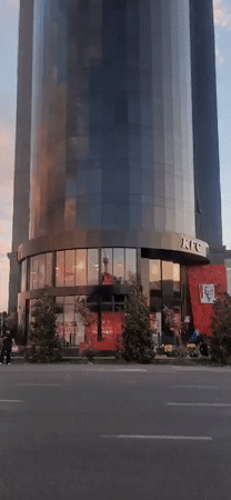 Outside a Tashkent KFC at the base of a glass tower