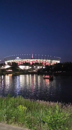 Warsaw's Vistula riverfront glows on a summer evening