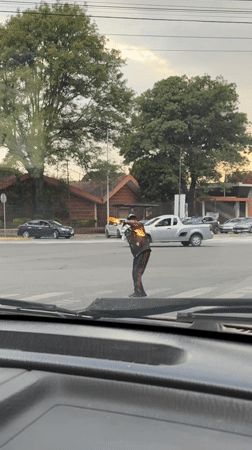Street performer juggles fire in Puebla intersection