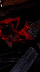 Close-up looks at glowing charcoal and burning embers