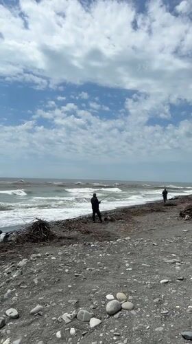 Two people fishing on rocky beach in Sirius, Russia