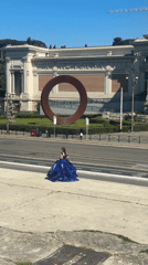 Woman in blue gown spotted near grand Roman building