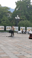 Street musicians perform in coastal plaza as families gather