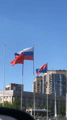 Flags wave in sunny Krasnoyarsk urban scene