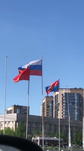 Flags wave in sunny Krasnoyarsk urban scene