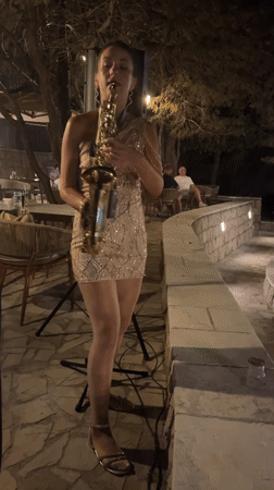 Live saxophone performance at an outdoor venue in Pečurice