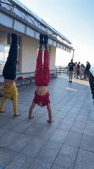 Side-by-side handstands on a patio in Bistritsa