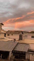 Colorful sunset with rainbow illuminates Florianópolis residential area