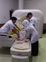 Patient prepared for CT scan by medical team