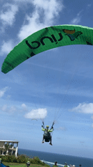 Paragliders fly over Kuta Selatan fields Saturday morning